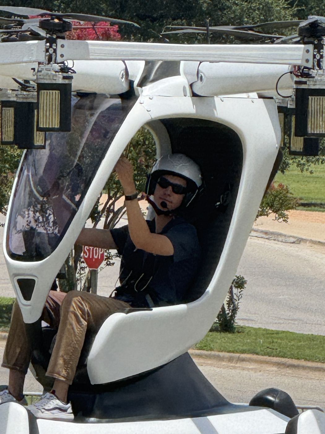 Spencer seated in the cockpit of the HEXA eVTOL wearing a helmet