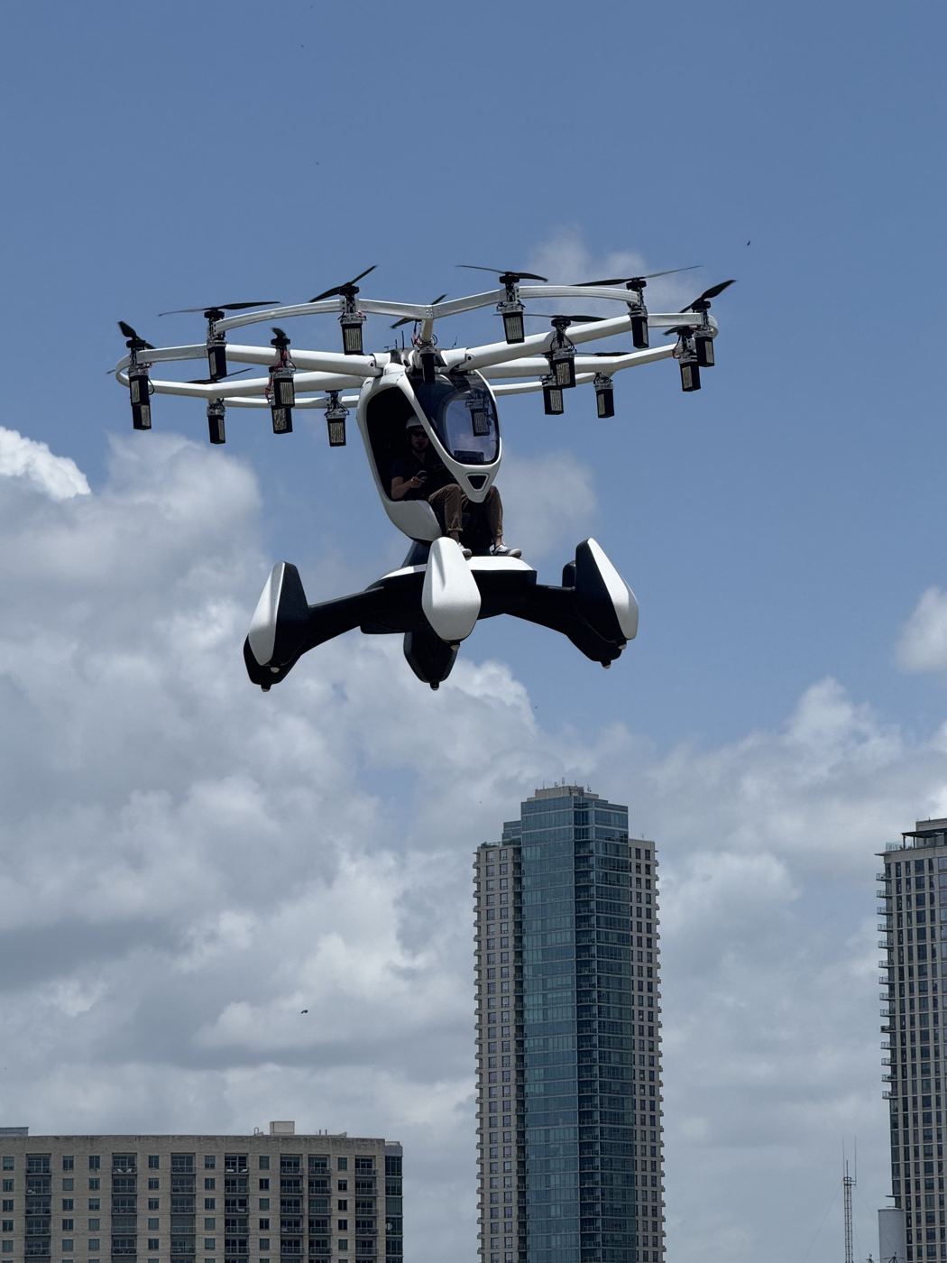 The HEXA eVTOL aircraft flying over the Austin skyline