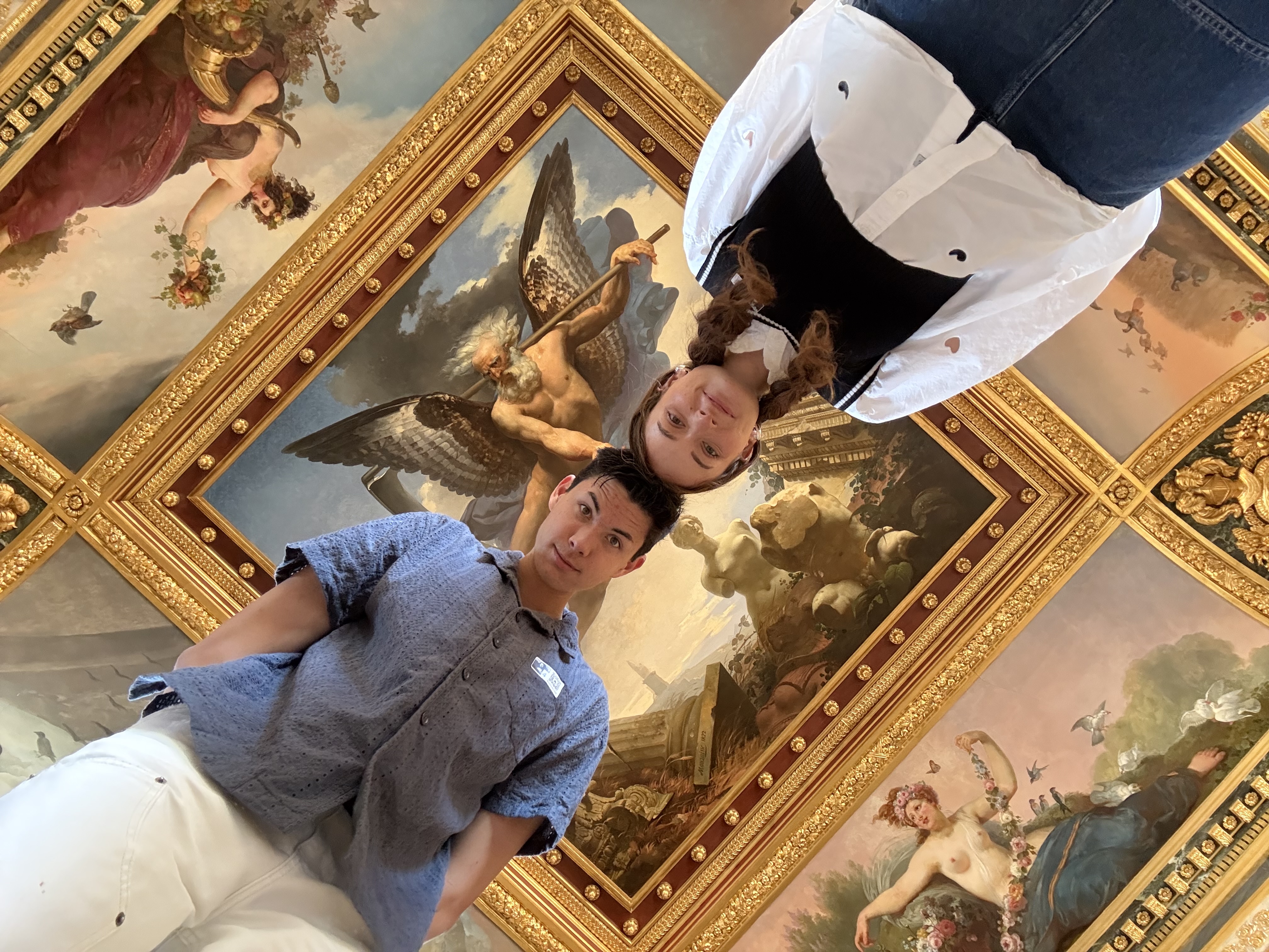 Spencer and Kali at Versailles lying on the floor to see the ceiling