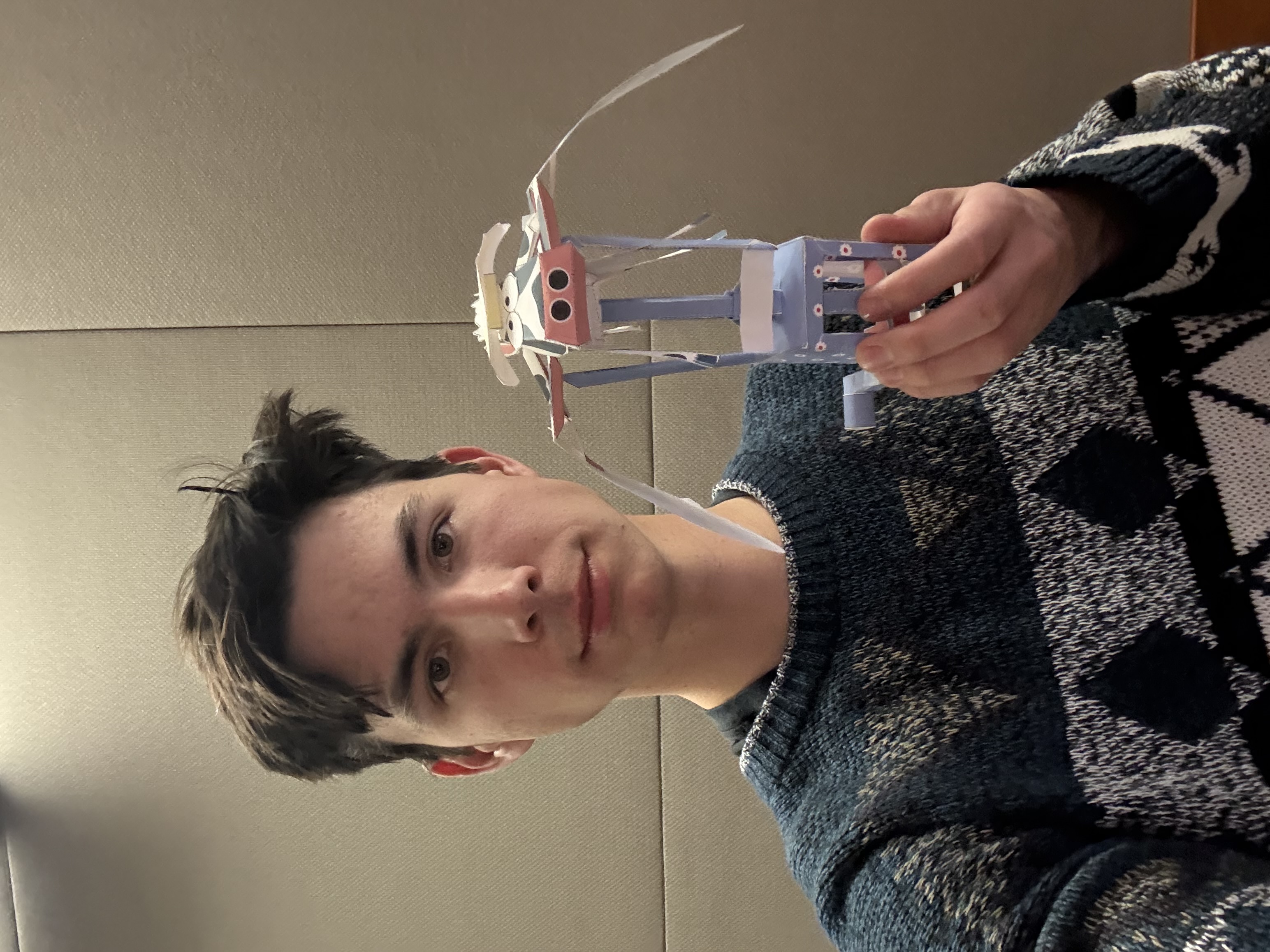 Spencer holding a small robot he built